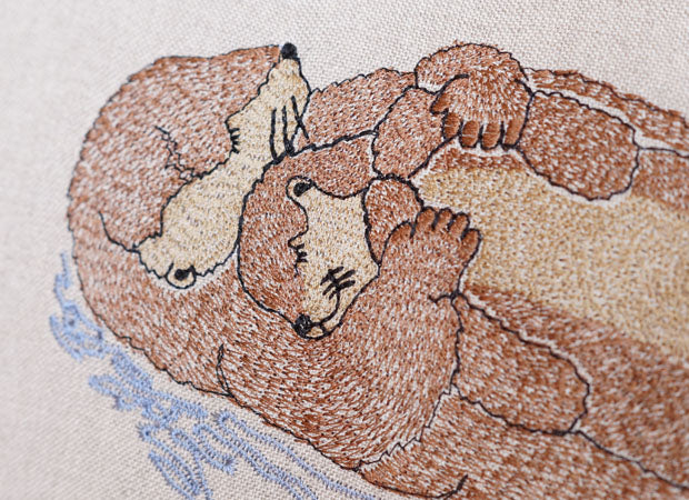 Sleeping Otter Mum and Pup Embroidered Cushion Close up Shot by Kate Sproston Design